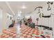 Spacious basement area with red and white checkered floors and workout equipment at 1275 Otis St, Lakewood, CO 80214
