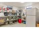 Basement storage area with shelving units and a refrigerator at 1275 Otis St, Lakewood, CO 80214