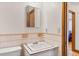 Cozy pink and white bathroom featuring retro tiles, a classic sink, and access to a modern shower at 1275 Otis St, Lakewood, CO 80214