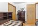 Bedroom featuring built-in closet, hardwood floors, and wooden dressers and headboard at 1275 Otis St, Lakewood, CO 80214