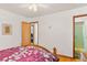 Bright bedroom featuring hardwood floors and ensuite bathroom with a door that leads to a fully tiled shower at 1275 Otis St, Lakewood, CO 80214