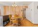 Traditional dining room with hardwood floors, retro wood paneling, table and chandelier at 1275 Otis St, Lakewood, CO 80214