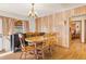 Traditional dining room with wood floors, wooden table, and vintage chandelier lighting at 1275 Otis St, Lakewood, CO 80214