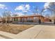 Lovely brick home with a long driveway, showcasing ample parking space and detached garage at 1275 Otis St, Lakewood, CO 80214