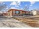 Picture of a brick home with a large driveway leading to the garage, complemented by a well-maintained lawn at 1275 Otis St, Lakewood, CO 80214