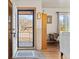 Entryway with hardwood floors, features a clear view to the front porch and cozy living room accents at 1275 Otis St, Lakewood, CO 80214