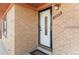 Inviting front door entrance featuring brick facade and visible house number, creates a welcoming approach to the home at 1275 Otis St, Lakewood, CO 80214