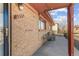 Inviting front porch with seating area and brick accents, enhancing the home's curb appeal and outdoor living space at 1275 Otis St, Lakewood, CO 80214