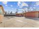 Expansive concrete driveway leading to brick detached garages at 1275 Otis St, Lakewood, CO 80214