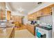 Kitchen area extends into a dining space with table and retro wooden paneling at 1275 Otis St, Lakewood, CO 80214