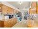 A large, functional kitchen with wood cabinets and ample counter space at 1275 Otis St, Lakewood, CO 80214