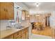 Kitchen area includes a sink and wood cabinets, extending into the dining space at 1275 Otis St, Lakewood, CO 80214