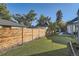 Green backyard featuring a well-maintained lawn bordered by a wooden fence and decorative landscaping at 1749 S Lincoln St, Denver, CO 80210