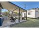Backyard featuring a covered patio with a built-in grill, outdoor seating, and artificial turf at 1749 S Lincoln St, Denver, CO 80210