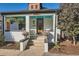 Close-up of a cozy front porch with hanging plants and decorative accents at 1749 S Lincoln St, Denver, CO 80210