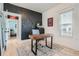 Bright home office featuring a modern desk, textured wall, and natural light at 1749 S Lincoln St, Denver, CO 80210