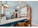 Eat in kitchen with updated cabinets, stainless steel appliances, and a breakfast bar at 1749 S Lincoln St, Denver, CO 80210