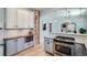 Bright kitchen with updated cabinets, stainless steel appliances, and a breakfast bar at 1749 S Lincoln St, Denver, CO 80210