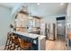 Updated kitchen with white cabinets, stainless steel appliances, and a stylish breakfast bar at 1749 S Lincoln St, Denver, CO 80210