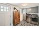 Modern laundry room with sleek cabinets, designer tile, and stainless-steel appliances at 1749 S Lincoln St, Denver, CO 80210