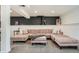 Spacious living room featuring a sectional couch with decorative pillows and dark accent wall at 1749 S Lincoln St, Denver, CO 80210