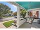 Inviting front porch features a porch swing, hanging plants, and comfortable seating at 1749 S Lincoln St, Denver, CO 80210