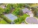 Aerial view of the home's exterior, manicured grounds, and a nearby tennis court at 7330 Routt St, Arvada, CO 80005