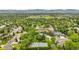 Scenic aerial view of a charming neighborhood with mature trees and a tennis court at 7330 Routt St, Arvada, CO 80005