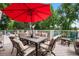 Outdoor dining area on back deck features an umbrella-covered table with plush cushioned chairs at 7330 Routt St, Arvada, CO 80005