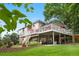 Multi-level backyard featuring a deck, patio, and green space at 7330 Routt St, Arvada, CO 80005