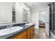 Bathroom features double sinks, granite counters and modern fixtures at 7330 Routt St, Arvada, CO 80005