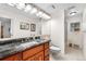 Full bathroom features a marble counter and shower with glass door at 7330 Routt St, Arvada, CO 80005