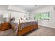 Carpeted bedroom with ample natural light and a decorative bed at 7330 Routt St, Arvada, CO 80005