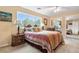 Cozy bedroom featuring a plush bed, end tables with lamps, and a mirrored closet across the room at 7330 Routt St, Arvada, CO 80005