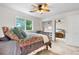 Bright bedroom with a ceiling fan, a window with a view, and a closet featuring a mirrored door at 7330 Routt St, Arvada, CO 80005