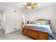 Bright bedroom with a patterned bedspread, a ceiling fan, and easy access to the en-suite bathroom at 7330 Routt St, Arvada, CO 80005