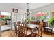 Elegant dining room with hardwood floors, large windows, and traditional furniture at 7330 Routt St, Arvada, CO 80005