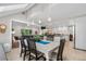 Open-concept dining room features pendant lighting and is adjacent to the living room and kitchen at 7330 Routt St, Arvada, CO 80005