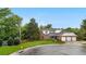 Beautiful home with a three-car garage, brick accents, mature trees, manicured lawn, and inviting curb appeal at 7330 Routt St, Arvada, CO 80005
