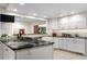 Bright kitchen features white cabinets, stainless steel appliances, and granite countertops at 7330 Routt St, Arvada, CO 80005