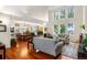 Open-concept living area flowing into the dining space, featuring hardwood floors and abundant natural light at 7330 Routt St, Arvada, CO 80005