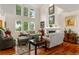 Bright living room with high ceilings, a fireplace, large windows, and hardwood floors for a spacious feel at 7330 Routt St, Arvada, CO 80005