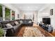 Comfortable living room with a large sectional sofa, hardwood floors, and plenty of natural light at 7330 Routt St, Arvada, CO 80005