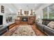 Cozy living room featuring a brick fireplace, wood floors, and comfortable seating at 7330 Routt St, Arvada, CO 80005