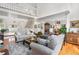 Open-concept living room with staircase, hardwood floors, and comfortable seating at 7330 Routt St, Arvada, CO 80005
