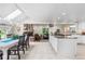 Open floor plan showing a dining room, fireplace and kitchen with lots of natural light at 7330 Routt St, Arvada, CO 80005