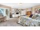 Comfortable main bedroom with decorative shelving, a full bathroom, and a comfortable sitting area at 7330 Routt St, Arvada, CO 80005