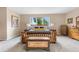 Comfortable main bedroom with a large window bringing the outdoors in and decorative accents at 7330 Routt St, Arvada, CO 80005