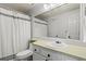 Bright bathroom featuring a large mirror, neutral-colored tile, and a shower with a modern rainfall showerhead at 1907 S Helena St # G, Aurora, CO 80013