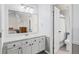 Bright bathroom features a vanity with storage, a mirror, and a doorway to a separate toilet and shower area at 1907 S Helena St # G, Aurora, CO 80013